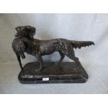 Hollow bronze figure of retriever dog, with game bird in mouth, set on a black marble base PLEASE