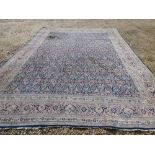 Large Persian carpet with all over floral leaf, palmettes & arabesques on a blue ground (burn
