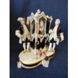 A Royal Dux porcelain with Lady in Sedan chair with 2 male attendants, printed mark PLEASE always