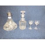 A silver mounted cut glass decanter, a further decanter & 2 sherry glasses PLEASE always check