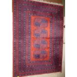 A red ground rug with a row of four shaped gulls 135 x 192 cm PLEASE always check condition PRIOR to