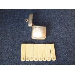 Modern silver cased peg marker case filled with 8 ivory markers, each numbered 1-8, Chester PLEASE