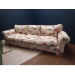 Large contemporary 3 seater sofa upholstered in cream fabric with modern floral pattern 94H x 250W