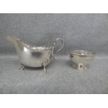 Silver sauceboat, 'Harrods' Birmingham 1936 with moulded shaped rim, double scroll handle on three