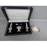 Cased silver three piece cruet set, by 'A. M. & Co.' Birmingham 1994; salt shaker, pepper and