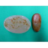 Carved agate pebble and piece of low skin jade