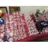 Large qty of glass incl. flutes, wine glasses, sherry glasses vases & coloured glasses