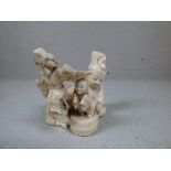 Carved ivory figure group depicting 2 Chinese figures holding carved figure models on sticks,