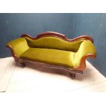 Victorian mahogany framed sofa on turned legs, upholstered in green velvet fabric