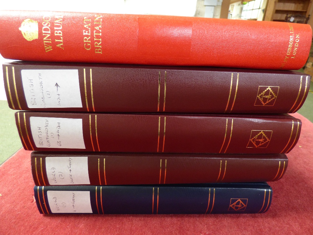 4 stock books of used white world & Windsor album of GB (u) (5)