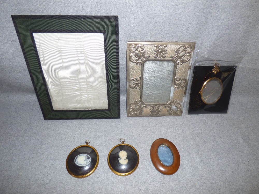 A selection of old portrait and photograph frames and two cameos