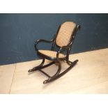 Edwardian back ebonised style child's rocking chair with cane seat and back; bears label 'Hornet' (