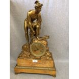 French gilt metal & marble base mantel clock in the form of a Roman gentleman figure standing on a