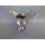 Hallmarked silver cream jug, London 1780, maker's mark 'C. H.' with embossed decoration of