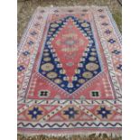 Persian style pink ground rug with multi colour geometric pattern 206 x 291 cm (stains/marks)