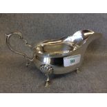 An oval silver sauce boat with scroll handle on hoof feet by 'Manoah Rhodes & Sons Ltd.' London