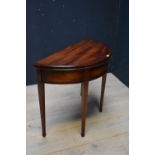 George III mahogany demi lune fold over card table on tapering legs 74H x 90W cm