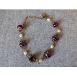 Art Nouveau bracelet, stamped '9ct' to the clasp with six cage set amethyst cabochons with
