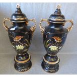 Pair of continental black & gilt glazed urns with bird & floral decoration 68H cm