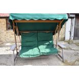 Teak swing garden bench with green awning