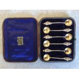 A set of 6 Victorian silver salt spoons with cast centurion terminal twist handles to gilt bowls