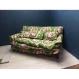 3 seater sofa in removable floral upholstery on mahogany legs & brass castors, 200L x 110W cm