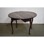 Small George III mahogany oval drop leaf, gate leg dining table on carved cabriole legs with pointed