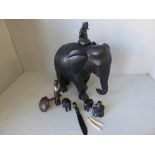 Carved black elephant with inlaid ivory style toes & tusk; other carved elephants & tribal
