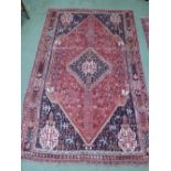 Middle Eastern rug. Rose coloured ground with floral pattern. 160 x 248cm