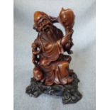 Chinese hard wood carved figure of a scholar on hardwood stand. 20 cm h.