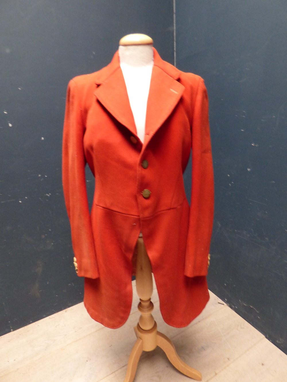 Red hunting coat, with brass buttons, bears label Jones Chalk & Dawson, 6 Sackerville St