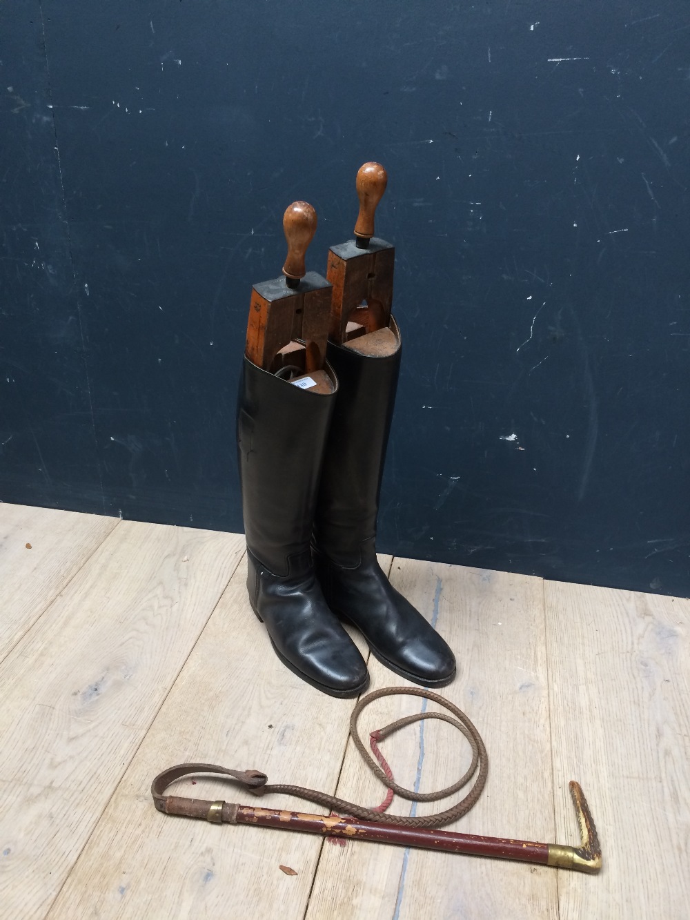 Gentleman's black leather hunting boots with trees & pulls, and a hunting whip