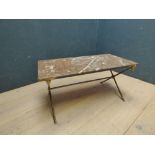 Decorative marble top coffee table on a brass X-frame stand, the stand capped with goat heads &