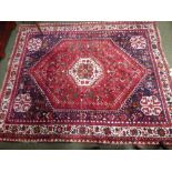 Small Iranian rug with a red ground. 210 x 167 cm