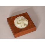 Chinese wooden square scroll weight inlaid with a jade 'dragon' disc, 8.5cm wide. Please check