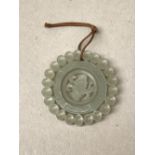 Chinese Jade pendant, with revolving centre disc, 5.5cm diameter, Provenance: lots 1001-1006: