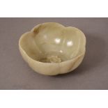 C17th Chinese jade petal-form bowl, moulded in the central with a blossoming prunus, and carved to