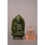 Chinese spinach jade figure of Guanyin, modelled seated on a double lotus base holding a vase in her