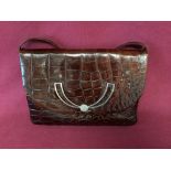 Brown handbag, with decorative clasp, and adjustable strap