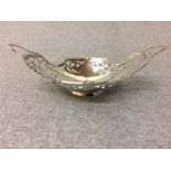 A pierced hallmarked two handled bon bon dish London 1927 18cm long 81g (2.6 ozt) gross with a two