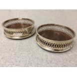 Pair of hallmarked silver bottle coasters with galleried rims, London 1971