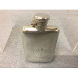 A hallmarked silver hip flask Birmingham 1919 of curved rectangular form captive bayonet top