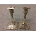 Pair of hallmarked silver stepped square base Corinthian column candlesticks, Sheffield 1873, 15cm