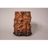 Chinese burlwood root-form brush pot, of gnarled and knotted shape, Qing dynasty, wood stand, 23.5cm