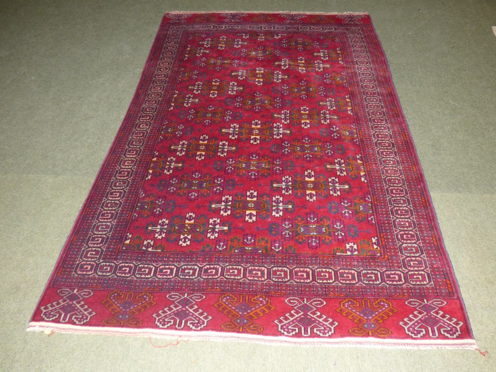 Persian oblong rug burgundy ground with all over geometric pattern and multi border 200 x 130