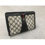 Ladies Gucci monogrammed clutch bag