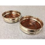 Pair of hallmarked silver bottle coasters with plain rims, London 1962