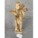 C19th carved ivory figure of a fisherman carrying a cormorant, 25.5cm H Please check condition