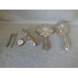 Hallmarked silver backed hand mirror with two matching brushes, Georgian silver sugar tongs, a