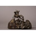 Chinese bronze brush rest cast with am immortal standing on the back of dragon and holding a shoe